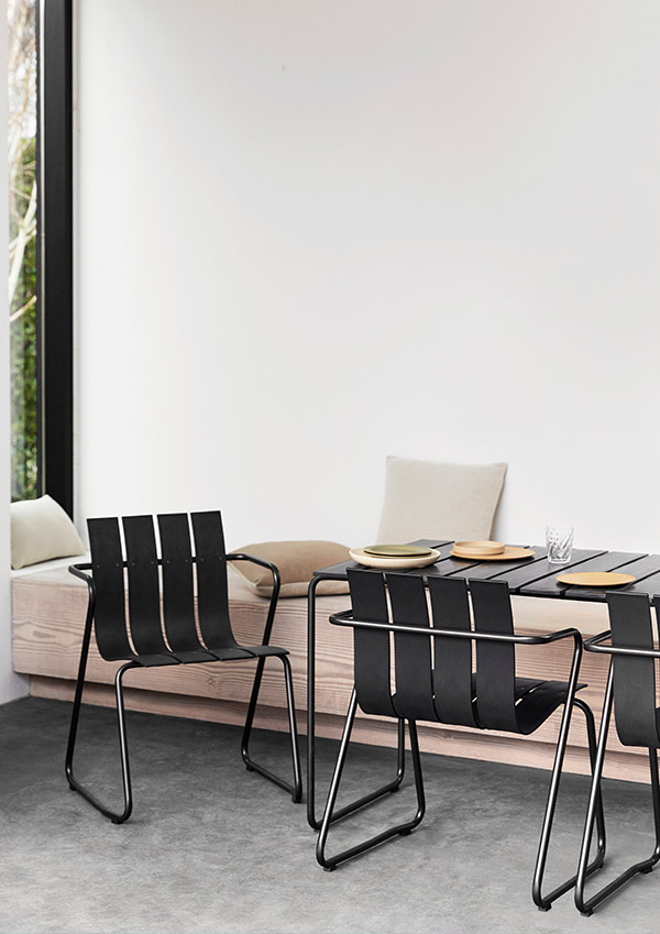 The Mater Ocean chair in black around a dining table