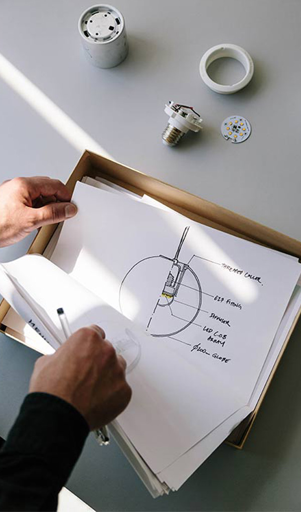 Designer Tim Rundle leafing through his designs