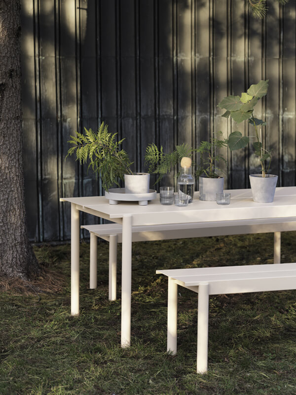 White Muuto Outdoor Linear Steel Dining Set in garden