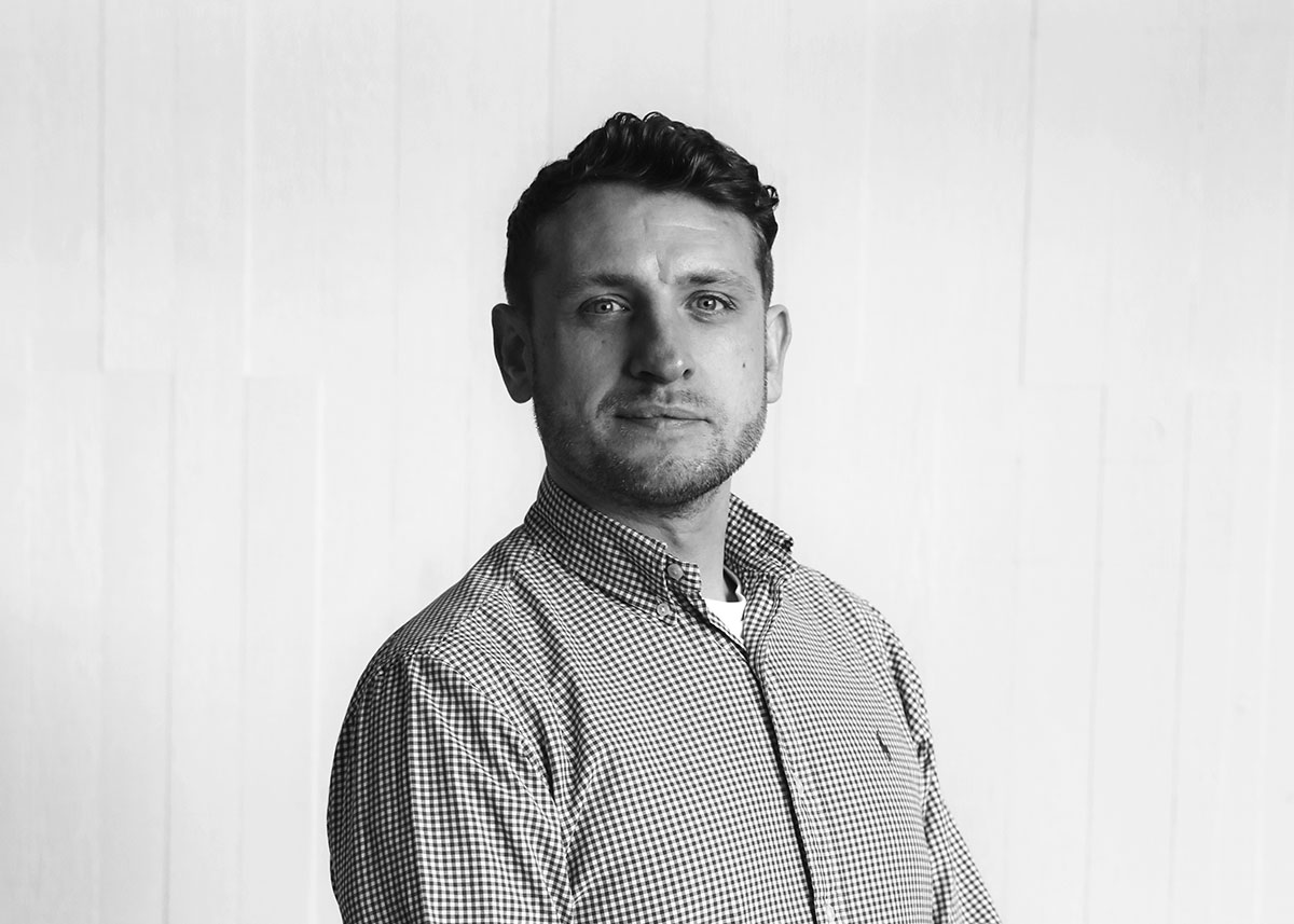 A black and white portrait of Nest Contracts' Douglas Fawcett