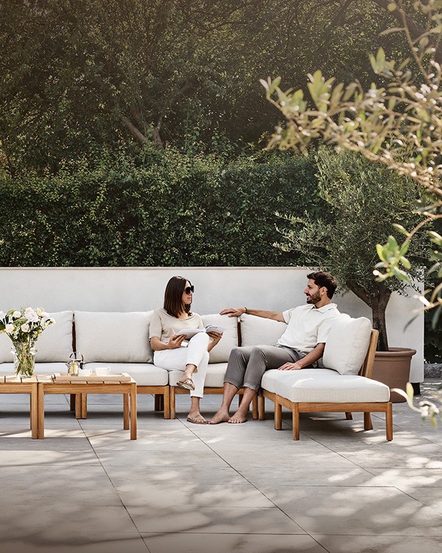 2 people sat on an outdoor sofa