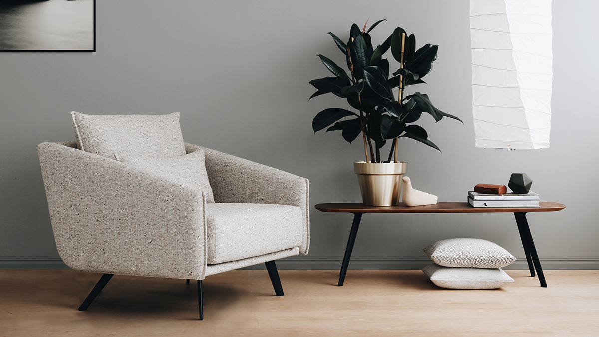 The STUA Solapa Coffee Table next to a neutral armchair