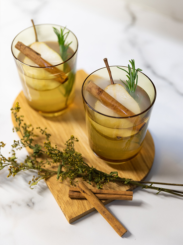 Looking down on the Muuto Raise Glasses filled with a Honey Pear Margarita Cocktail