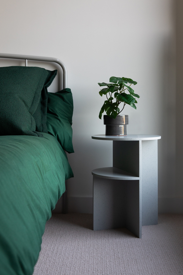 A Muuto halves table used as a bedside table