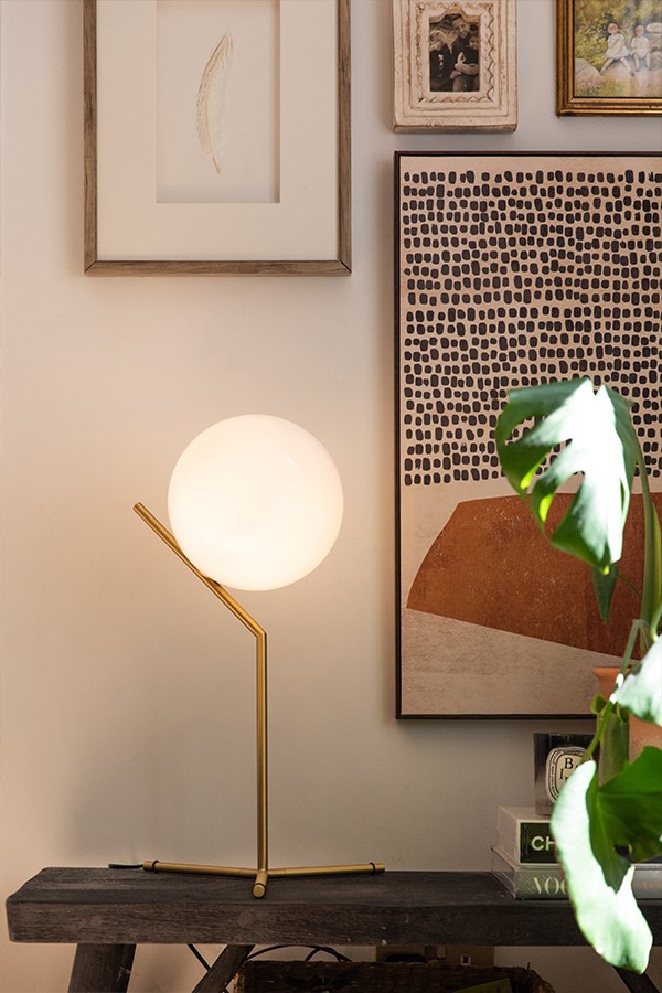 Brass FLOS IC T1 High Table Lamp on a bench