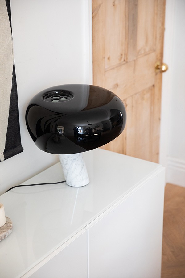 FLOS Snoopy Table Lamp on a white sideboard