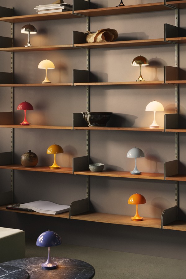 Collection of all colourways of the Louis Poulsen Panthella 160 Portable Table Lamp V3, on wall shelving