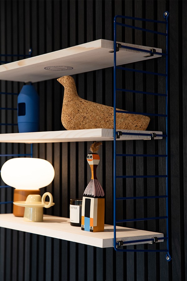 String 1949-2024 75th Anniversary Shelf in blue and pine, adorned with giftable items from Nest
