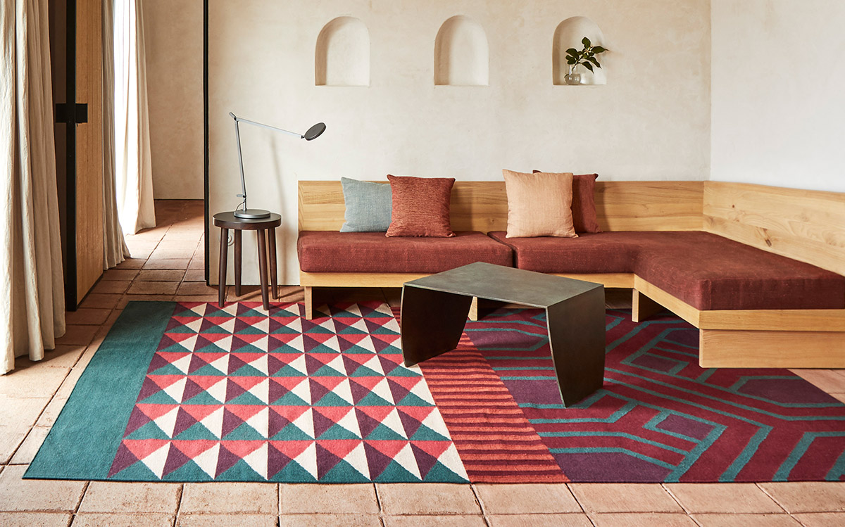 The GAN Kilim Ndebele Rug with a wooden sofa and coffee table