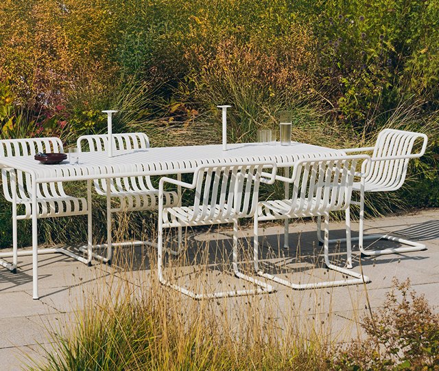 HAY palissade dining setup in lush green setting 