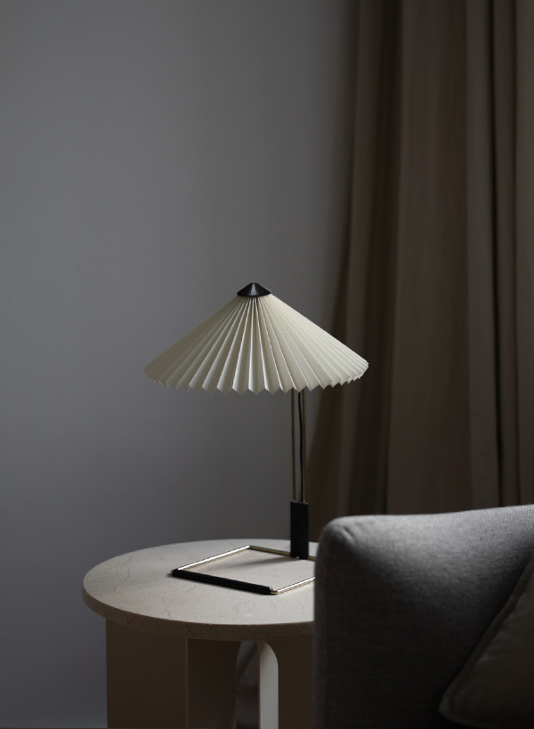 HAY Matin Table Lamp next to a sofa