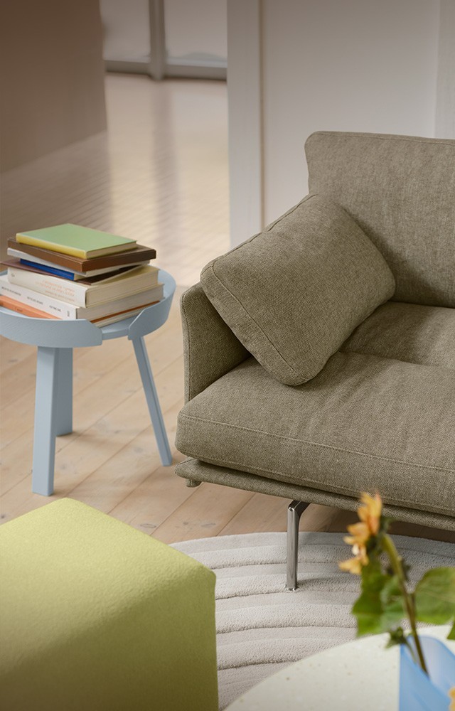 Muuto Outline Soft Sofa in Spring living room setting with sunflowers and books