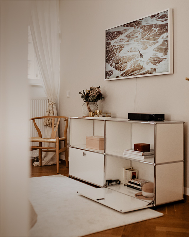 USM Haller Sideboard - Configuration 1 in bedroom space filled with items to store