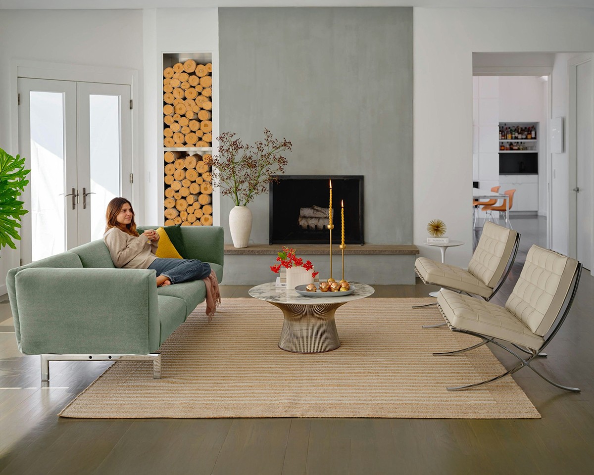 LAdy sitting in living room with Knoll Icons - Upholstered Matic Sofa & Barcelona Lounge Chair in leather 