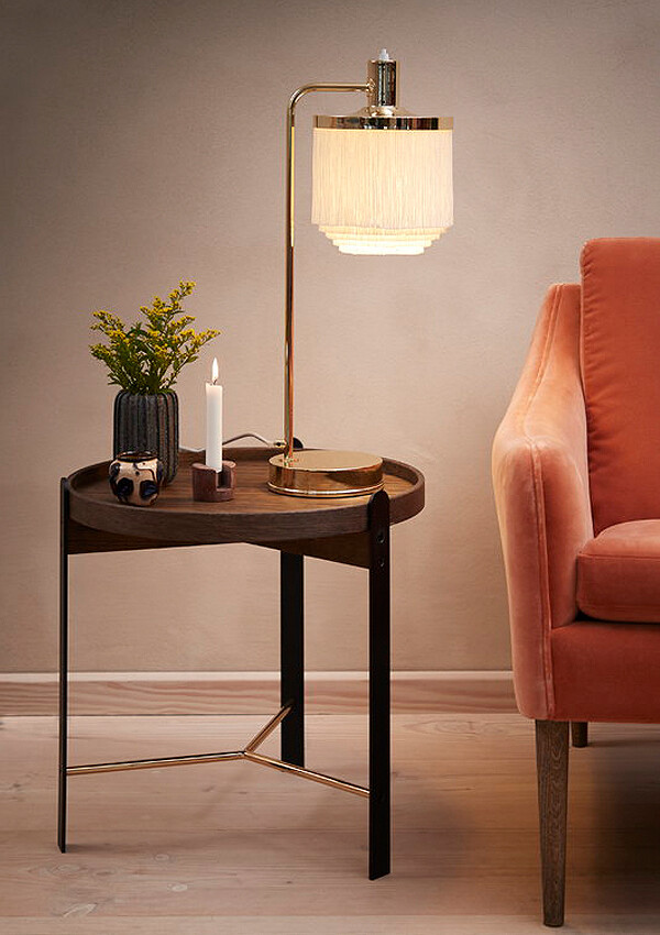 Warm Nordic Fringe Table Lamp beside a sofa