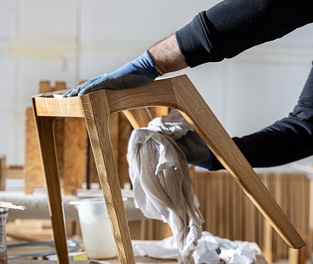 Image of Zeitraum craftsman polishing wooden stool