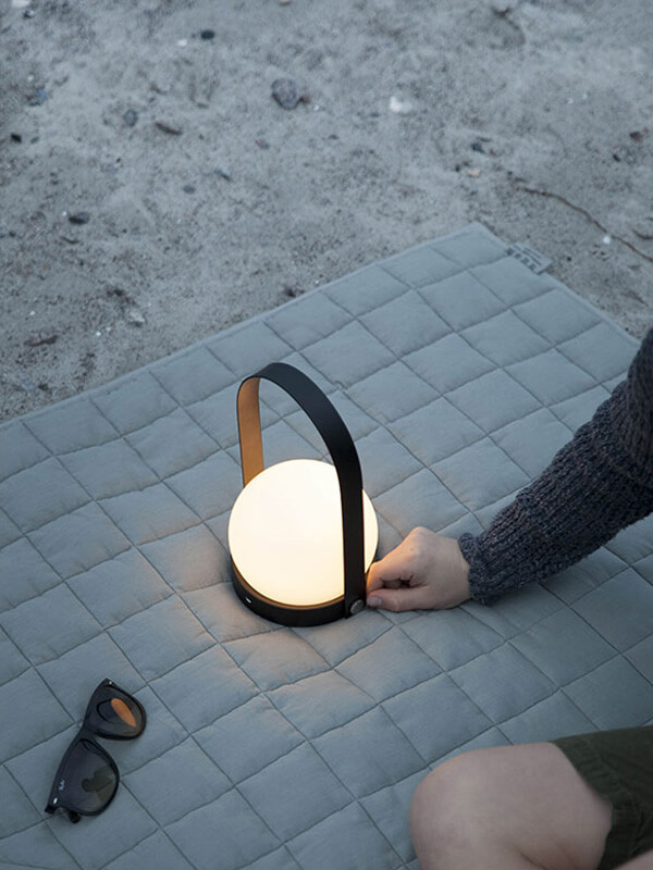 The Audo Carrie Portable Table Lamp at the beach