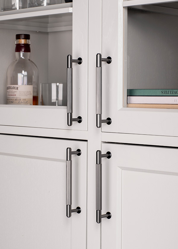 White cupboard doors with Buster + Punch Closet pull bar handles