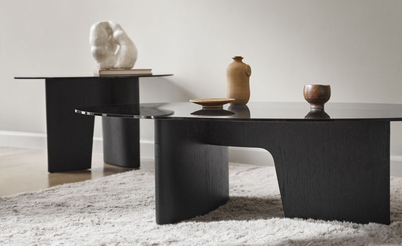 2 black wooden coffee tables with ornaments on top